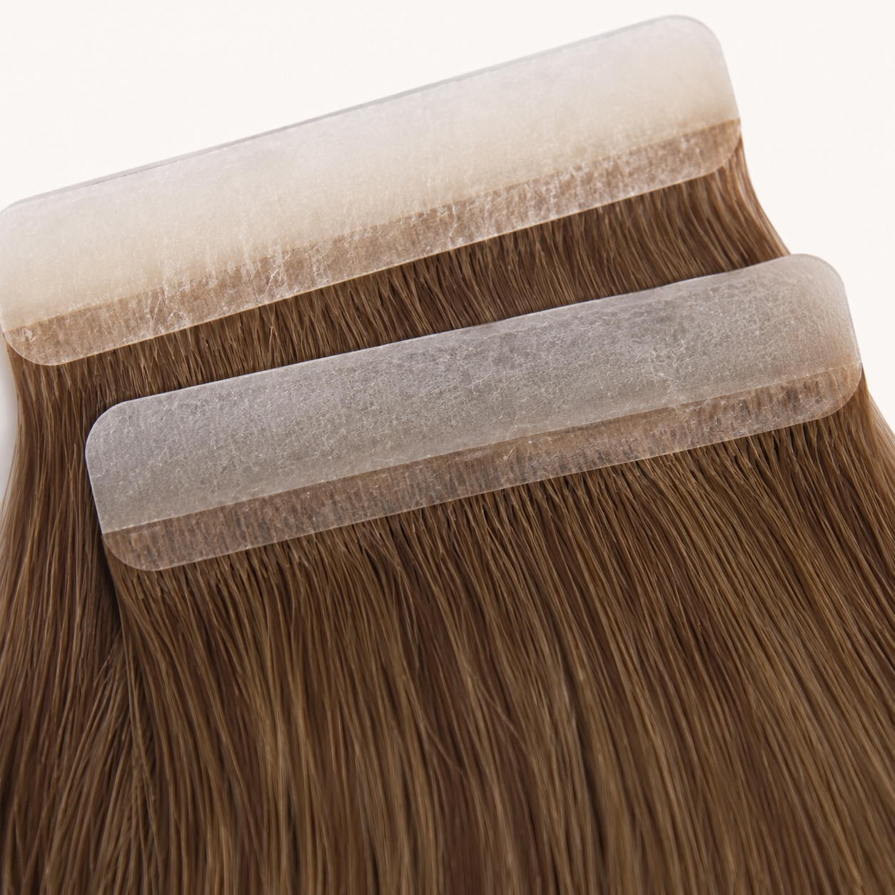 Close-up detail of Tape-In hair extension adhesive tabs